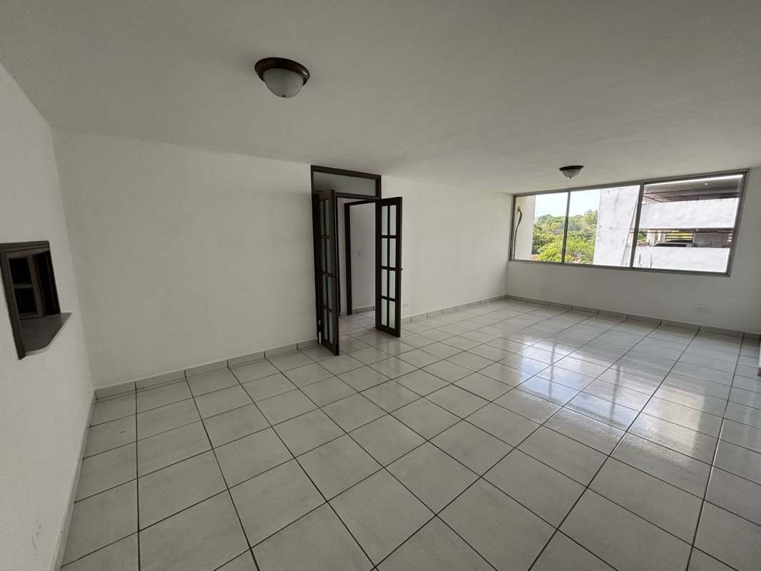 Bedroom with large window, built-in wardrobe, split AC and ceiling fan in PH Via Porras San Francisco Panama City