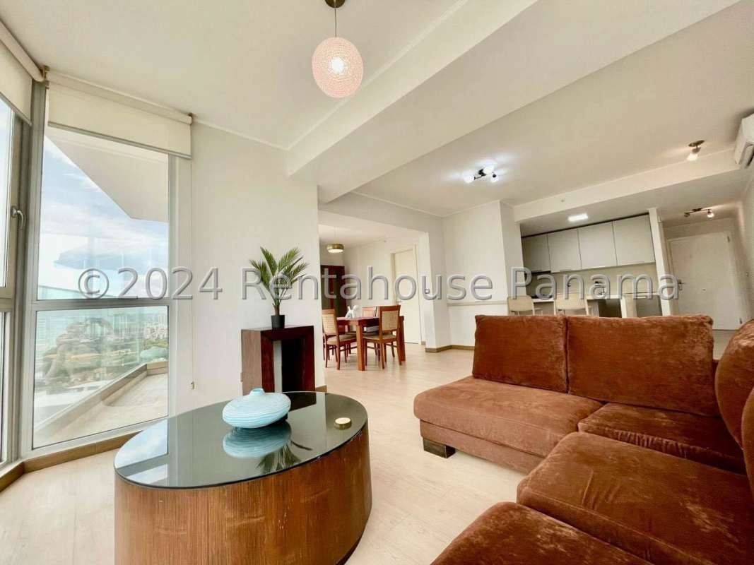 Spacious open-plan living and dining space with floor-to-ceiling windows and city views Quartier Del Mar Coco del Mar Panama