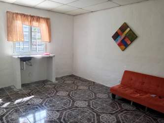 Simple interior room with yellow curtains patterned tile floor in Gorgona Panama budget rental
