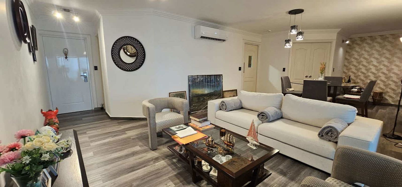 Modern open-plan living dining space with ocean view balcony in PH Royal Pacific Punta Pacifica