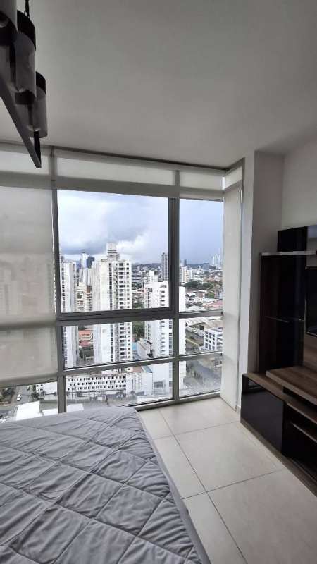Modern high-rise condo with outdoor swimming pool sun deck and lounge chairs Carrasquilla Park Panama