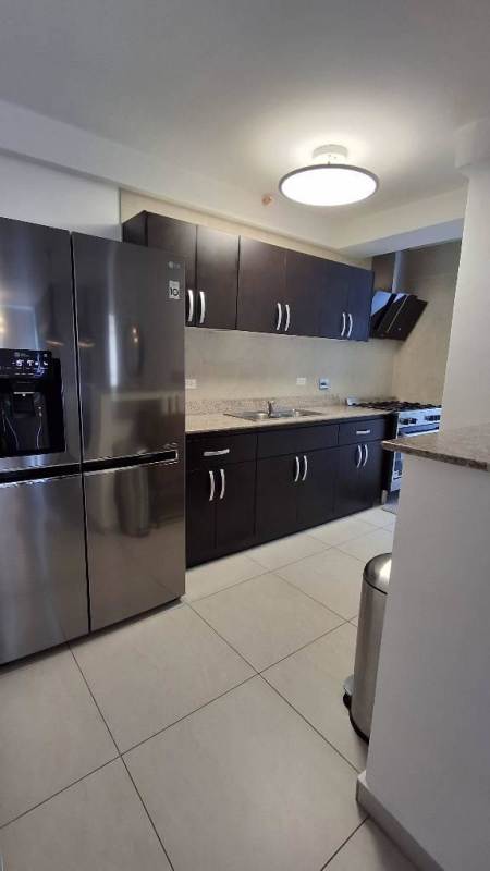 Kitchen with granite countertops stainless steel appliances dark wood cabinets PH Carrasquilla Park Tower Panama