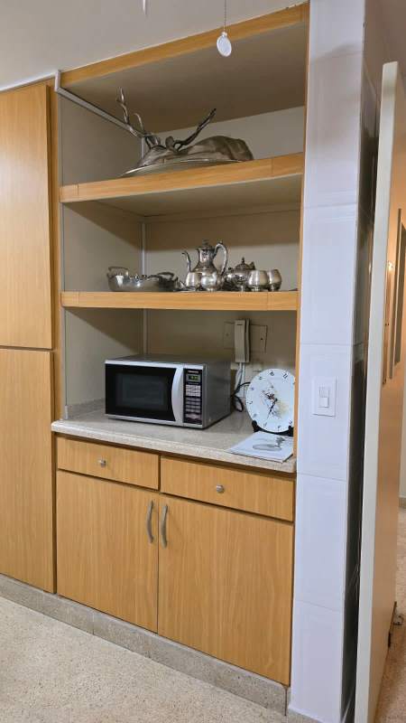 Traditional style wooden kitchen cabinets with built-in microwave in PH La Cresta Panama