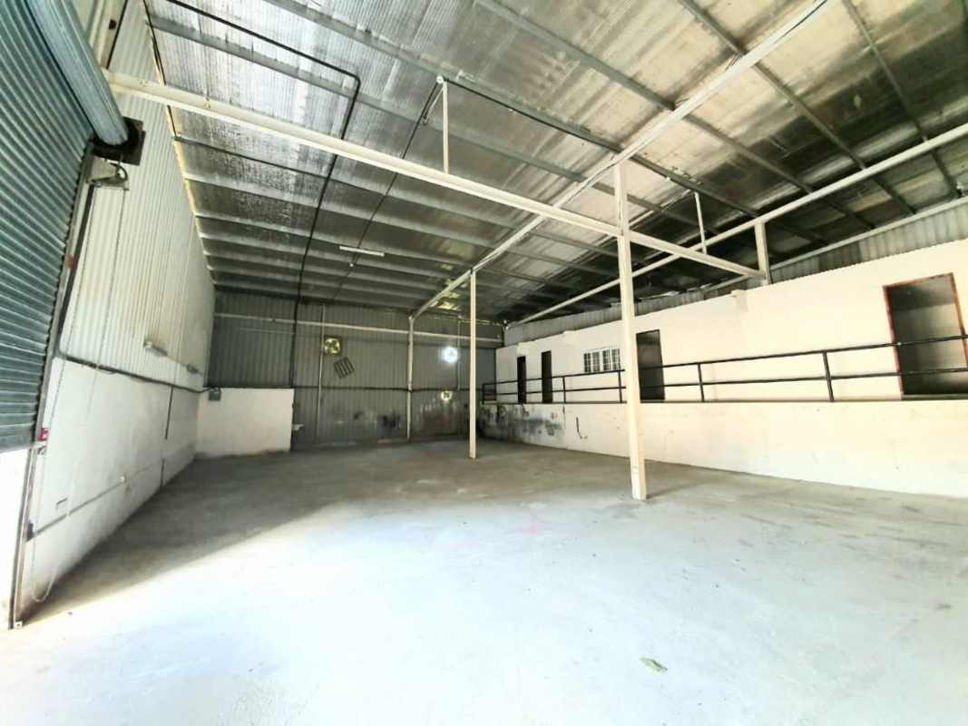 Industrial warehouse interior showing open concrete flooring and insulated roof