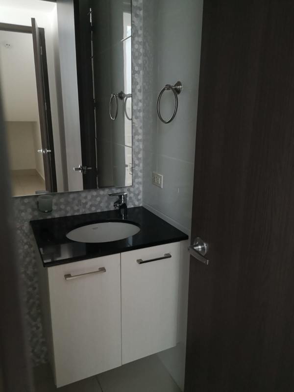 Minimalist white and black bathroom with large frosted windows PH Castellammare Costa del Este Panama