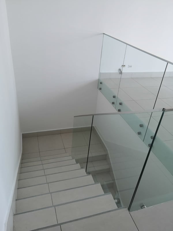 Minimalist staircase with glass railing in Costa del Este loft apartment Panama