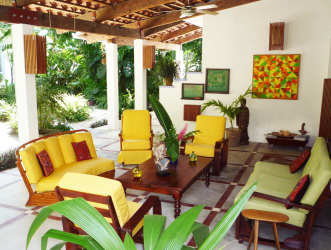 Bathroom with colorful mosaic wall tiles and glass block divider in Playa Blanca villa