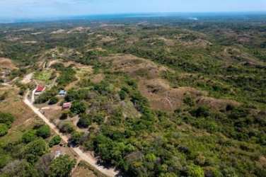 Aerial rural landscape with dirt road, scattered homesteads and horizon view Los Yerbos Panama