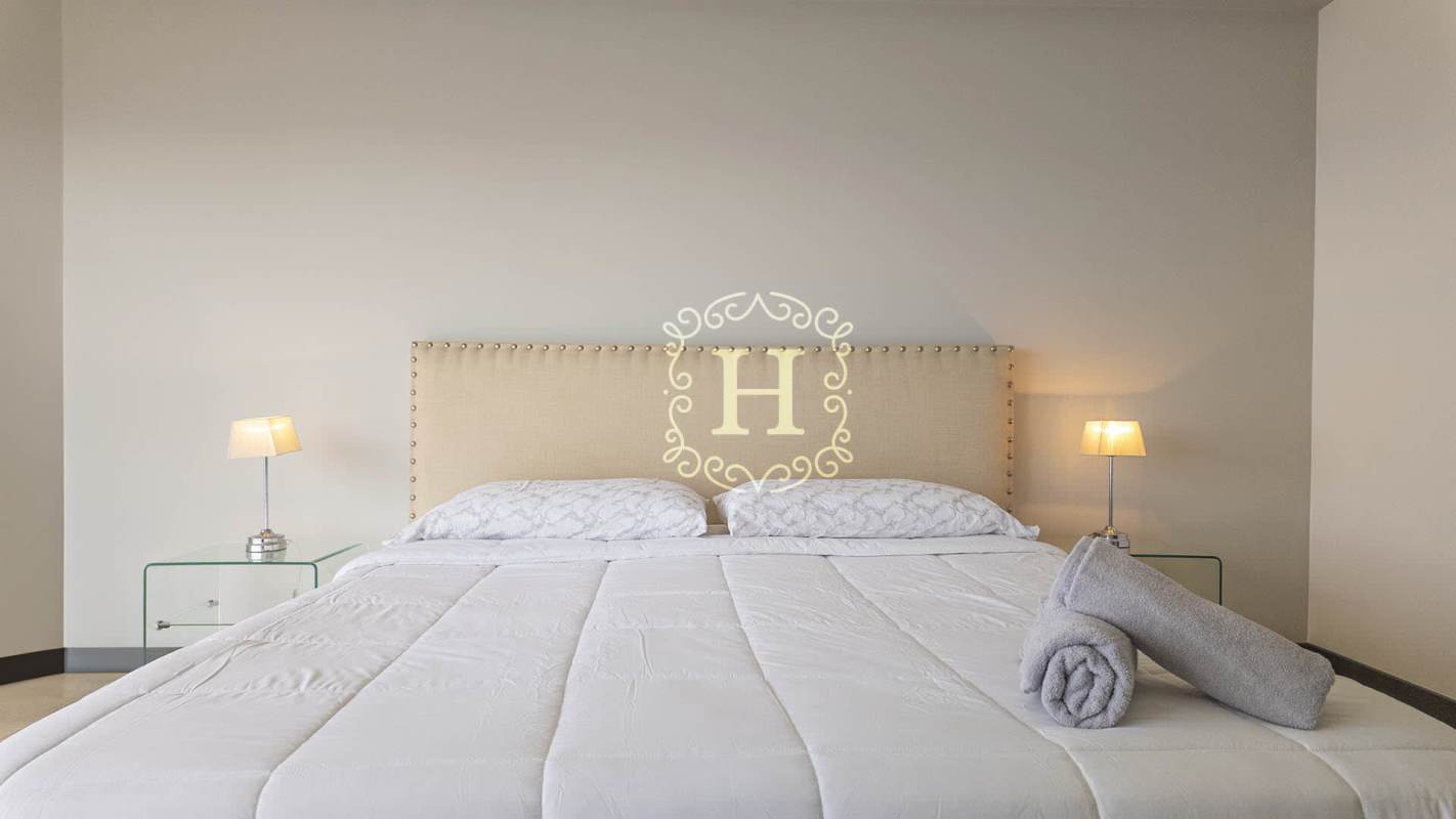 Modern open plan living and dining room with balcony and city views in The Ocean Club Panama