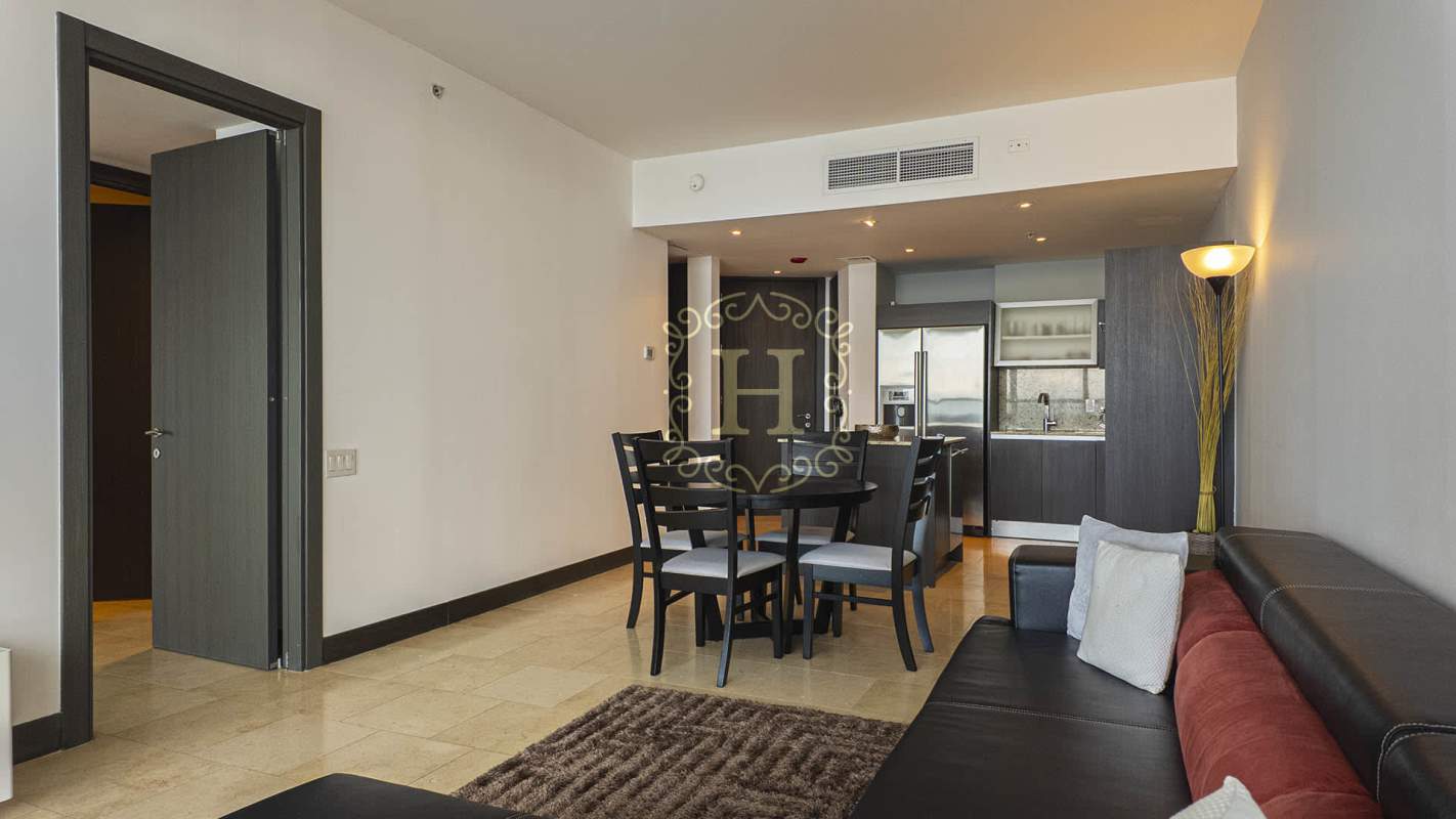 Luxury minimalist bedroom with large glass window offering ocean views at The Ocean Club Punta Pacifica