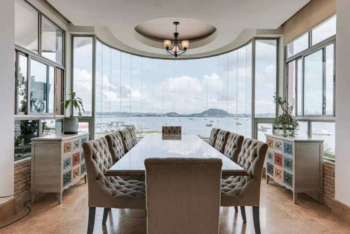 Modern dining area with panoramic floor-to-ceiling windows bay views in Penthouse Amador Heights Panama