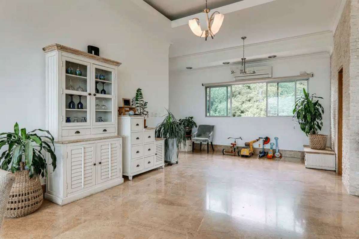 Spacious living room with floor-to-ceiling windows and panoramic Panama Bay views at PH Amador Heights Penthouse