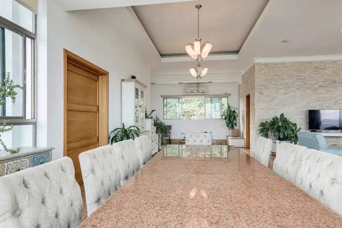 Open-plan modern kitchen with island, granite counters and water views at luxury penthouse PH Amador Heights