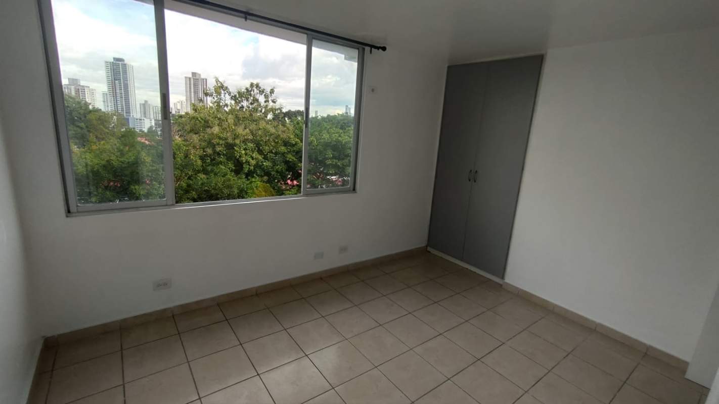 Bedroom with large window closet ceramic tile floors in apartment PH Altos de la Colina