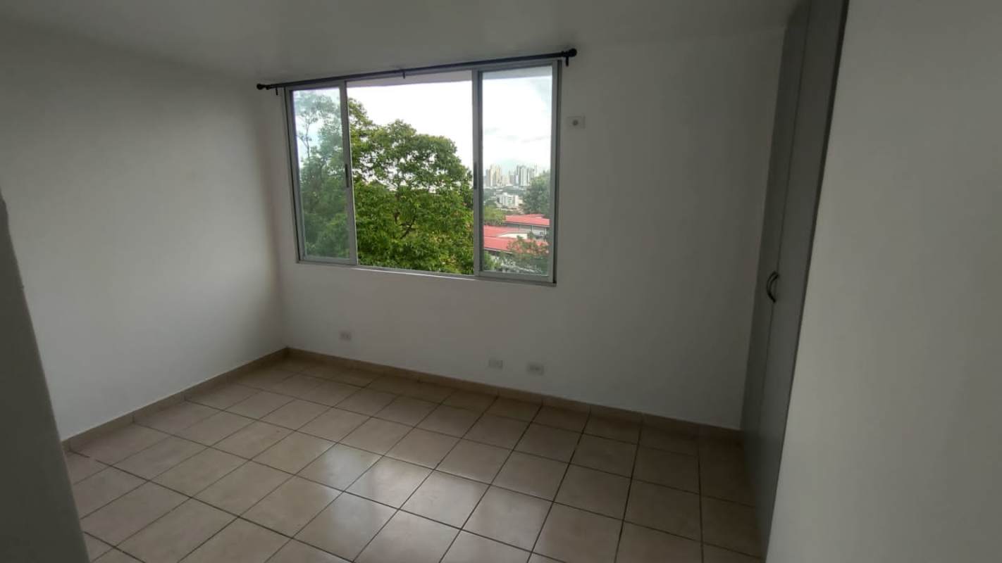 Functional kitchen area with window and ceramic backsplash in rental apartment Panama
