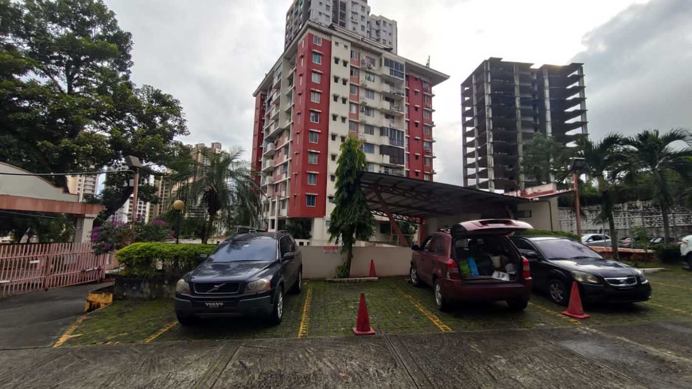 Mid-rise apartment building with covered parking landscaped urban area in Panama City