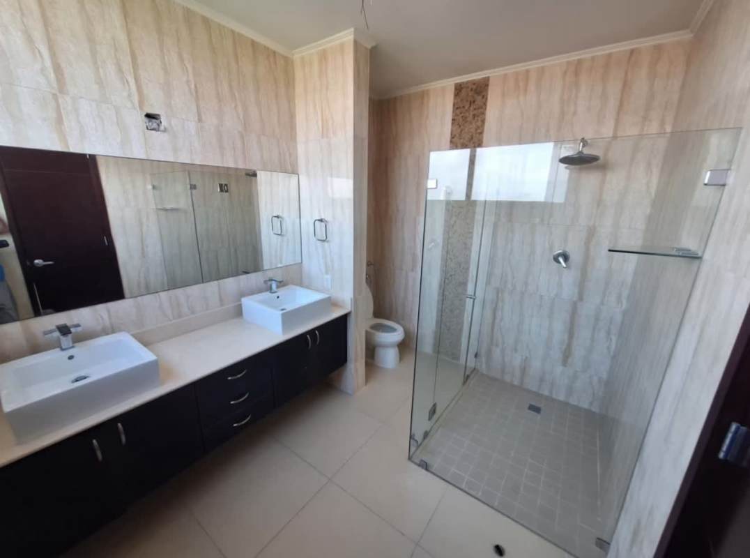 Modern bathroom with dual sinks, large mirror and shower PH Breeze Costa del Este Panama