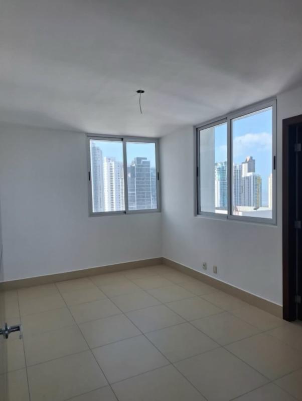 Remodeled kitchen with granite countertops, large window, beige cabinets in Breeze Costa del Este apartment Panama