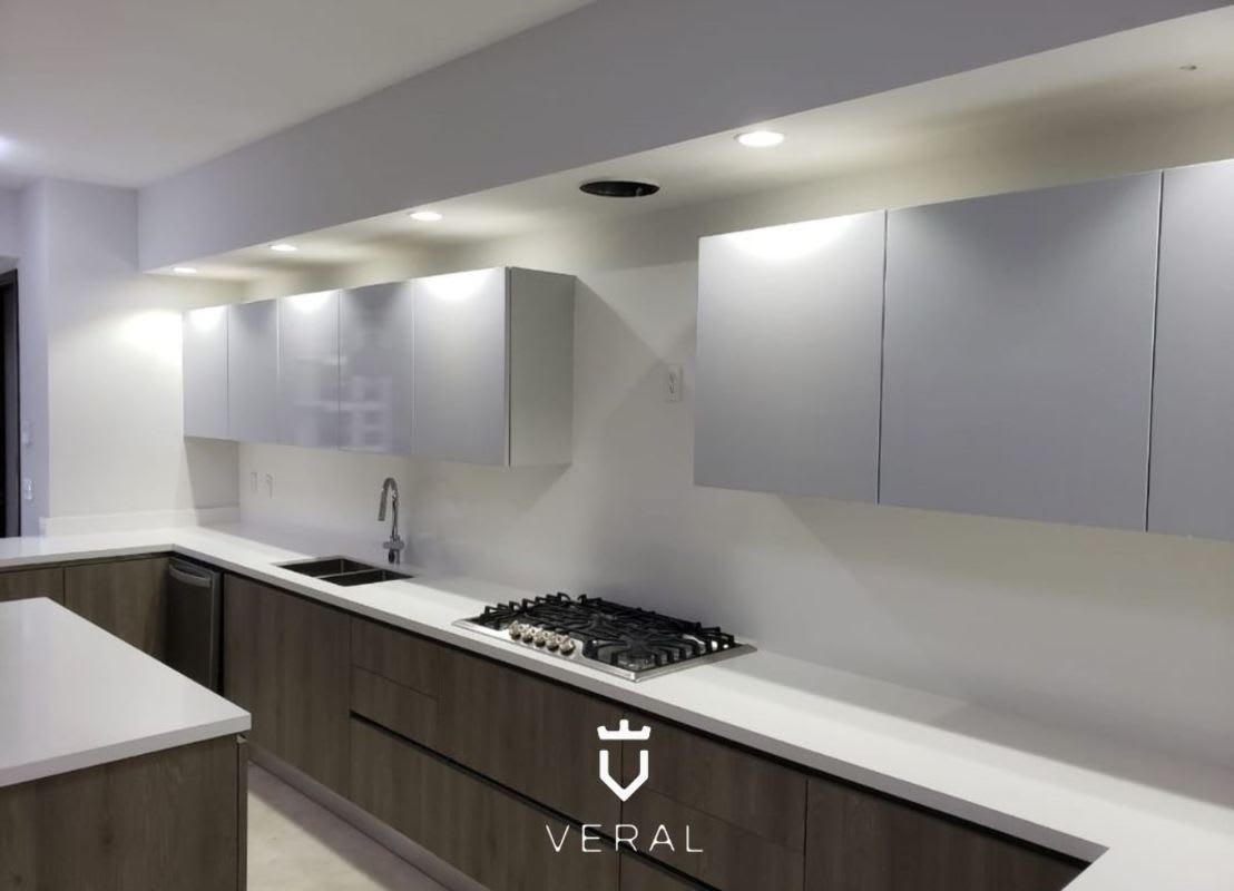 Contemporary kitchen with marble floors, high-end cabinetry, and island at PH Greengarden Santa María Panama