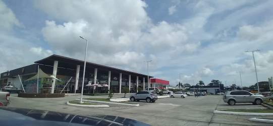 Retail strip mall with multiple glass storefronts at Uniplaza Costa Verde in Panama Oeste