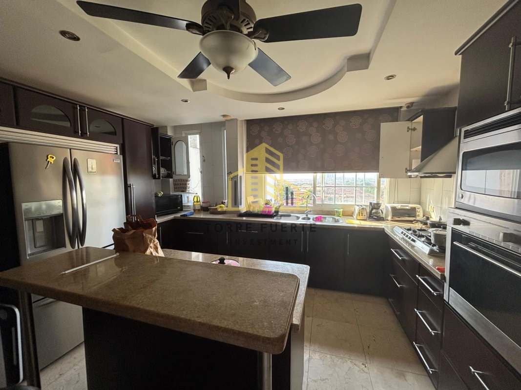 Dark cabinetry modern kitchen granite counters stainless appliances Brisas del Golf Panama