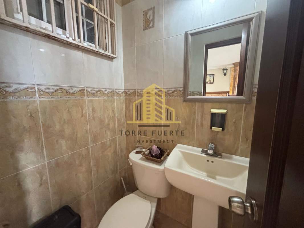 Compact bathroom with beige tiles floating sink security bars Brisas del Golf Panama