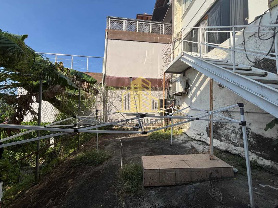 Exterior utility area with staircase banana plants drying rack Brisas del Golf Panama