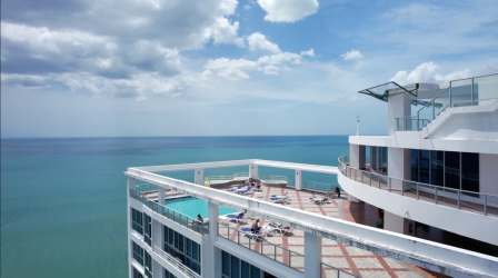 Master bedroom with ocean view windows in Coronado Bay apartment Panama