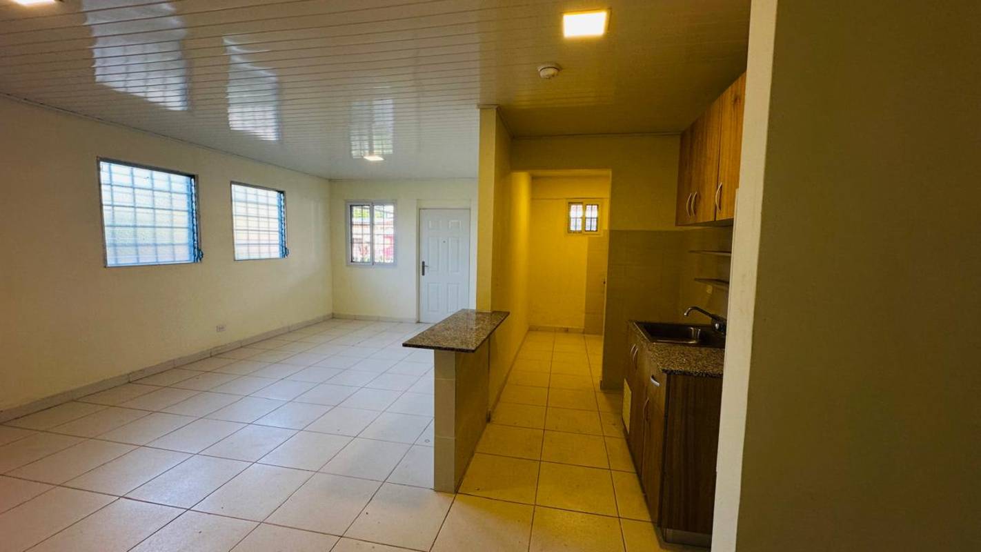 Bright living area open kitchen tile floor Betania apartment Panama