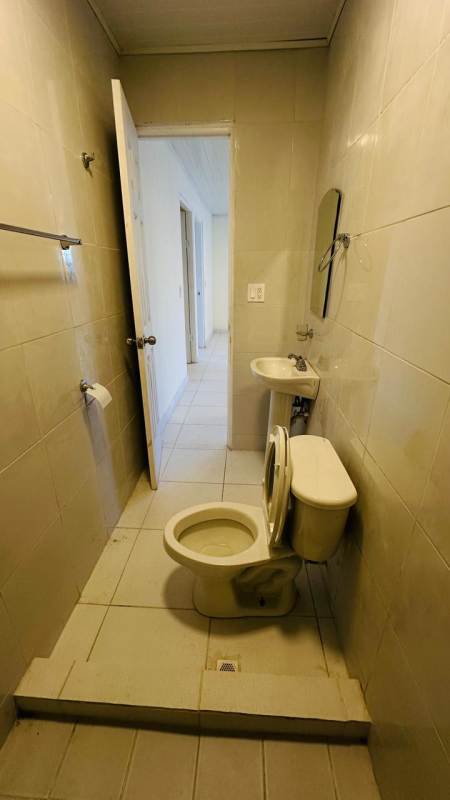 Compact bathroom with walk-in shower and beige tiles for rent Betania Panama