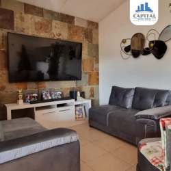 Yellow house with porch, decorative columns and gated yard for sale Residencial Las Verdes