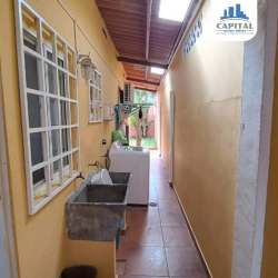 Laundry space with washer and sink in covered exterior of Arraiján house for sale