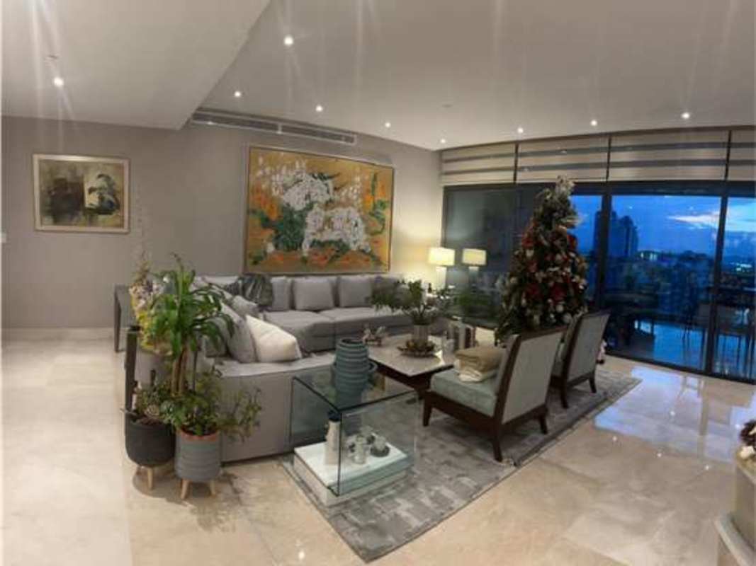 Master bedroom suite with large windows overlooking city and golf course at PH The Crescent Panama