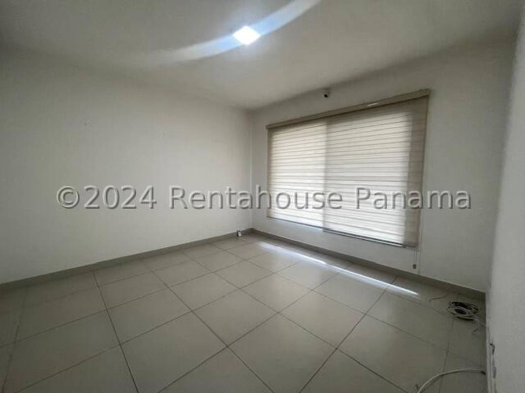 Bright bedroom with large windows tile flooring in Altos del Parque Panama