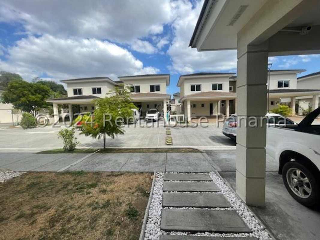 Outdoor swimming pool with gardens in gated community Altos del Parque Panama