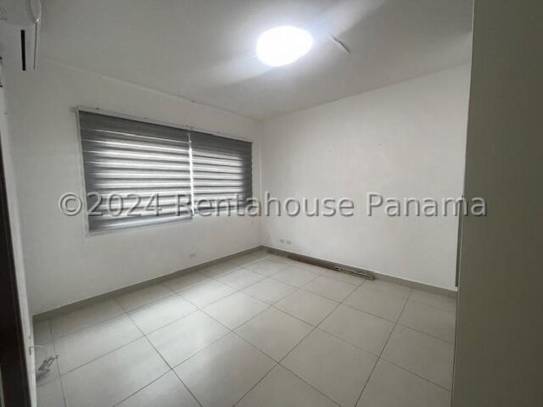 Spacious bedroom with tile flooring and closet in Altos del Parque Panama for rent