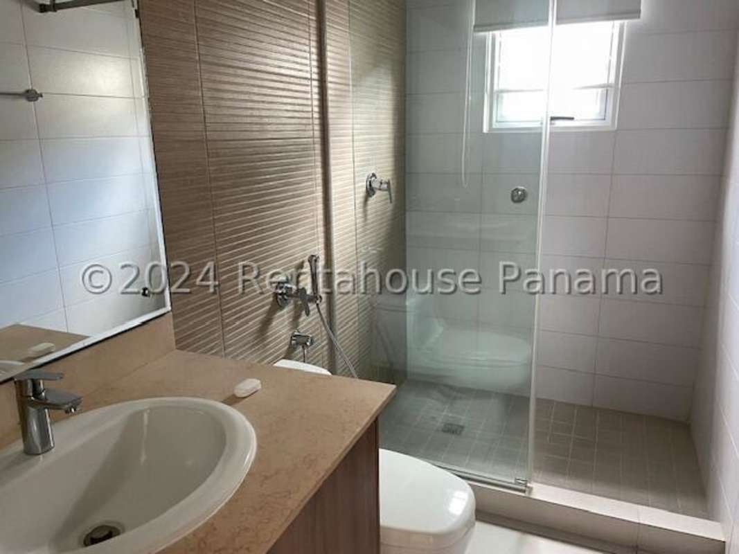 Modern bathroom with glass shower enclosure in Altos del Parque house Panama