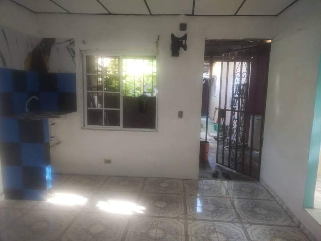 Small kitchen counter with blue black tiles tiled floor metal security door Las Mañanitas Panama