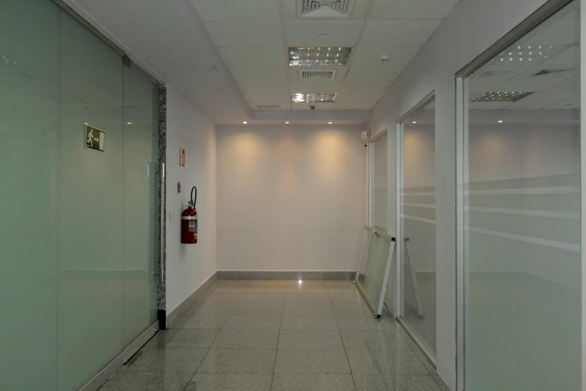Glass-partitioned office hallway with recessed lighting in PH BICSA Tower Panama City