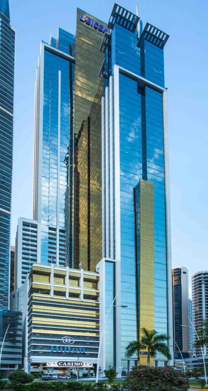 High-rise glass skyscraper with Hilton Hotel signage and casino on Avenida Balboa, PH BICSA Tower Panama City