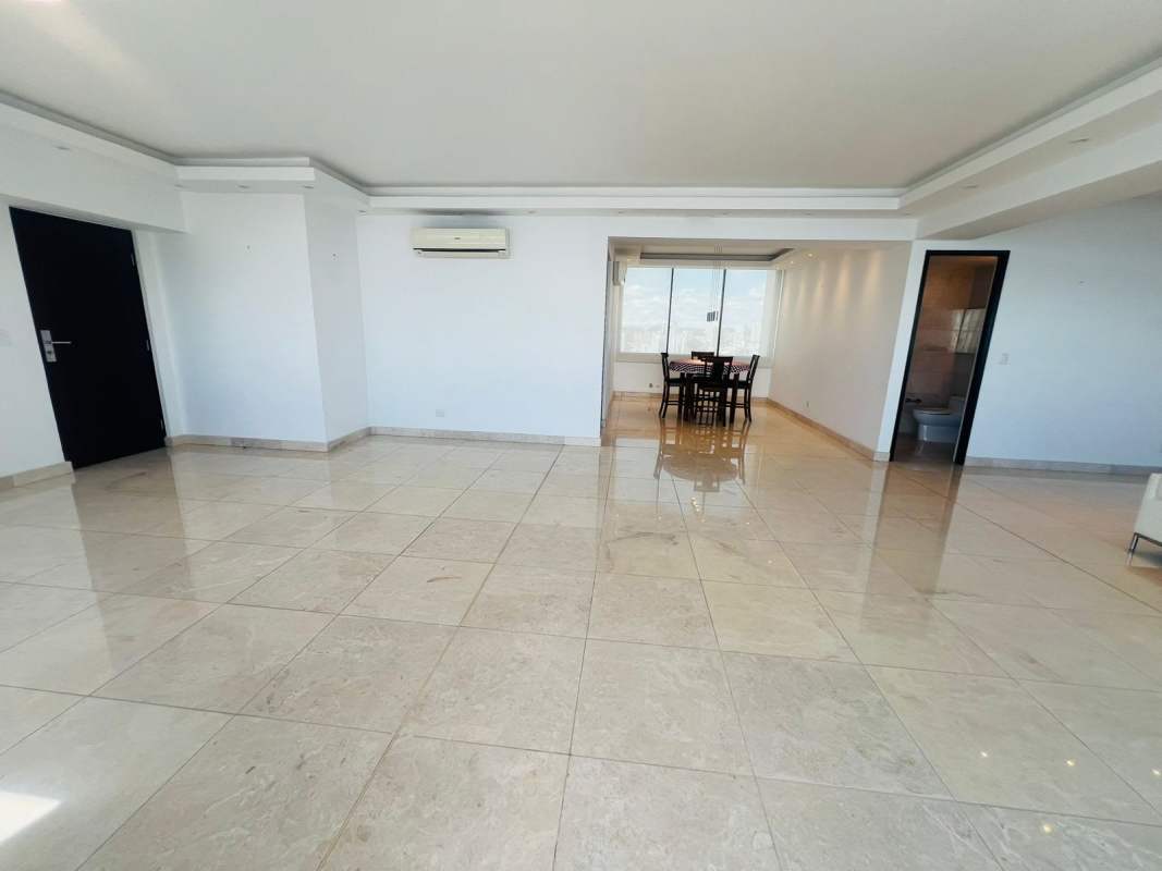 Spacious living area with marble floors and balcony access overlooking Pacific Ocean in Panama.