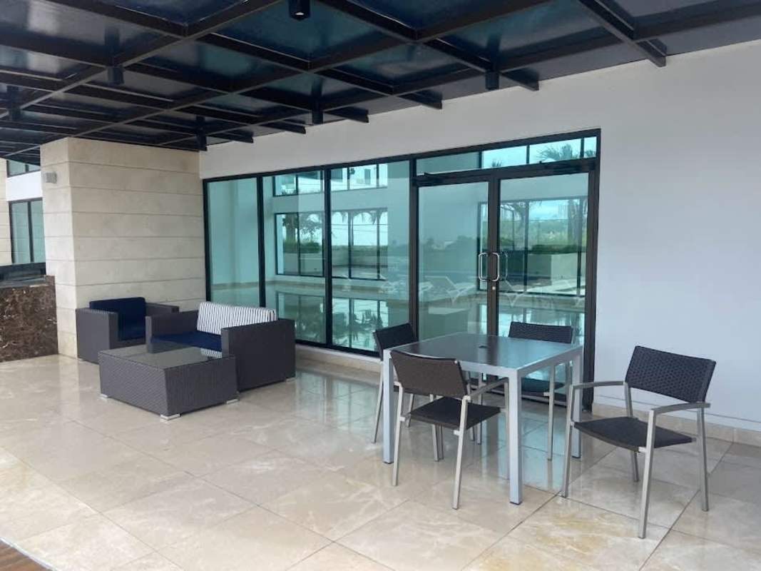 Modern bathroom with double vanity, marble finishes and glass-enclosed shower in Coco del Mar.