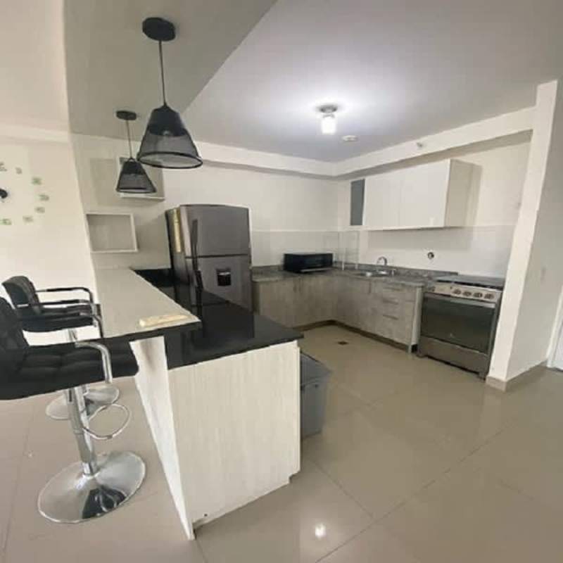 Modern kitchen with granite counter, gas stove, fridge and microwave in PH Diadema Panama