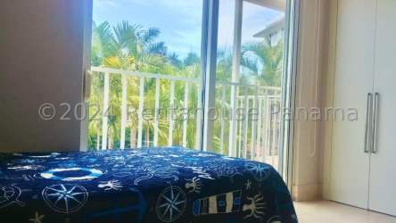 Bright coastal-style bedroom with balcony access in Puntarena Ocean Village Buenaventura Panama