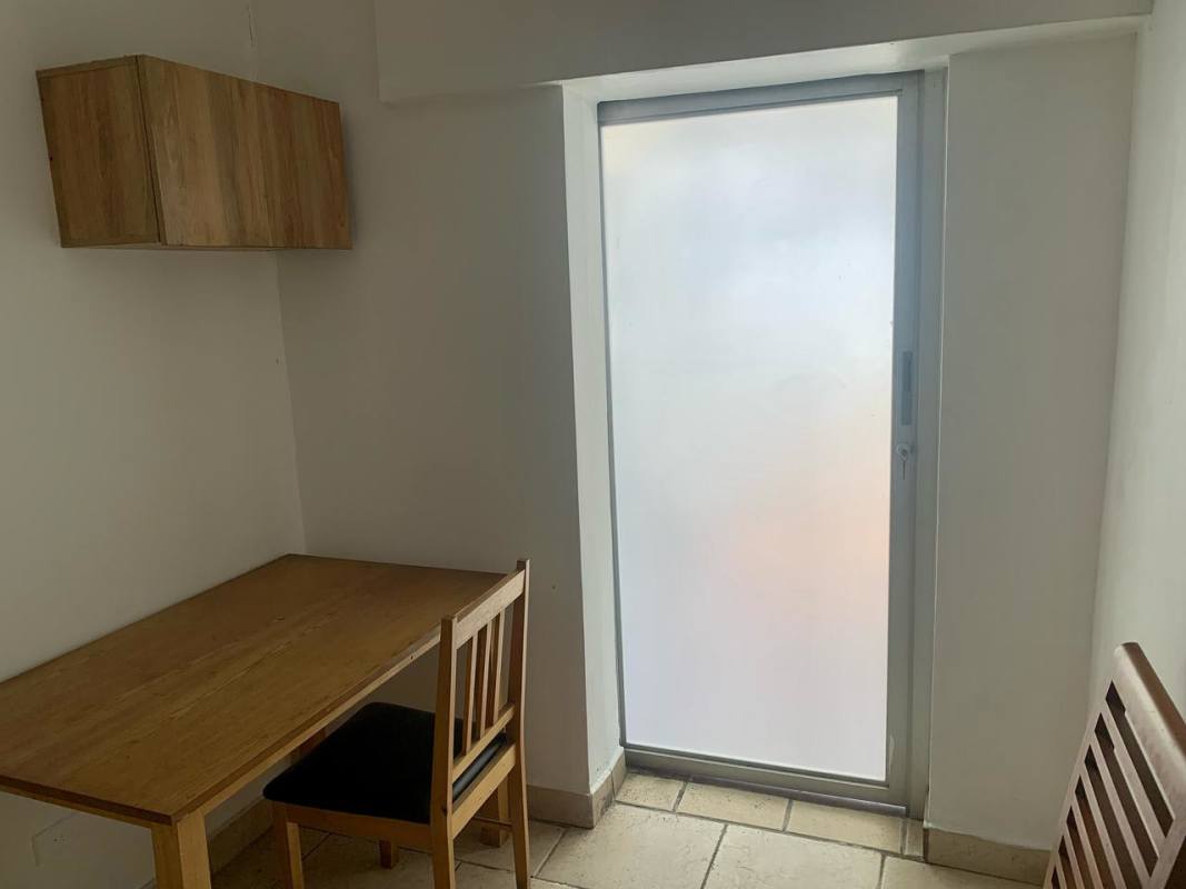 Spacious master bedroom with adjacent study area, wooden floors, ceiling fan in Deco Plaza Panama