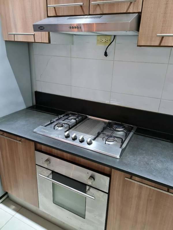 Contemporary hallway interior with stone textured accent wall and recessed lighting at PH San Francisco Apartment Panama City