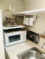 Mini kitchen furnished with gas stove, microwave, fridge at Arboledas Los Olivos Costa Verde