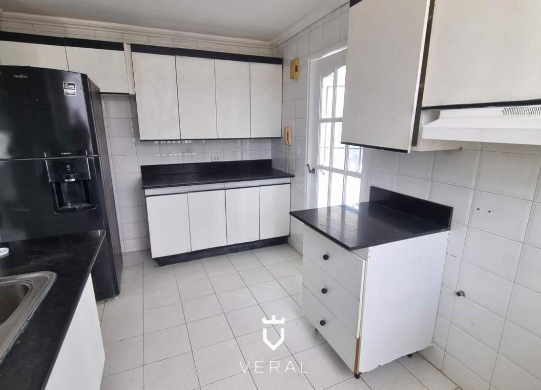 Spacious minimalist kitchen featuring black countertops, built-in cabinets, natural light PH Vista Tower Bella Vista Panama