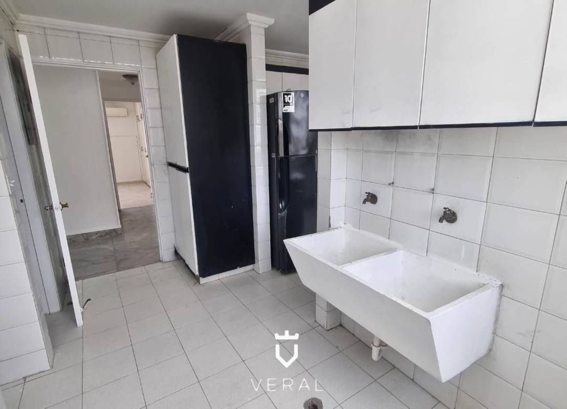 Laundry room with double utility sink, storage cabinets and space for washer/dryer in PH Vista Tower Bella Vista