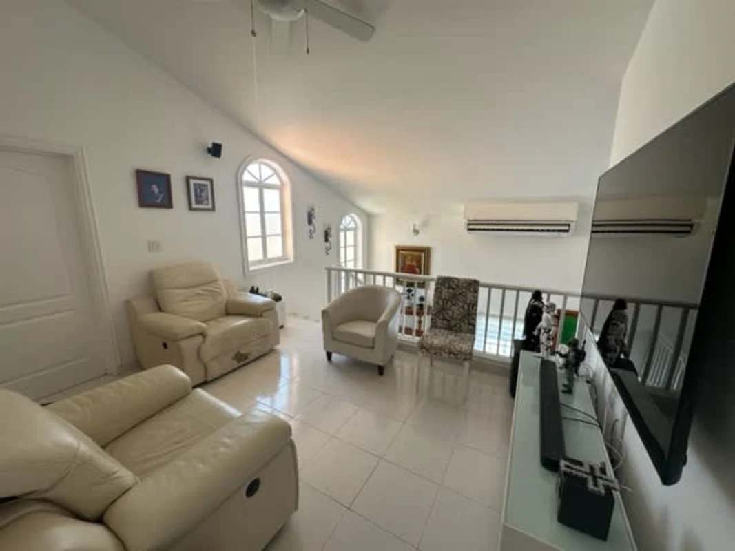 Modern kitchen with granite counters, white cabinetry, stainless appliances in Altos de Panamá house for sale